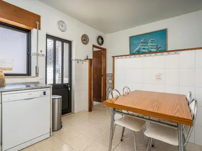 a kitchen with a wooden table and a table and chairs at Traditional house by the beach #1979 in Luz