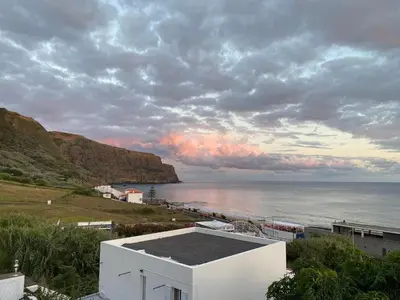 a view of the ocean under a cloudy sky at A casa da Xã in Almagreira