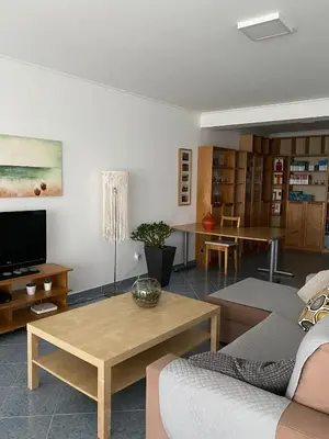 a living room with a couch and a table at A casa da Xã in Almagreira