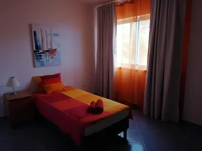 a bedroom with a bed with two shoes on it at A casa da Xã in Almagreira