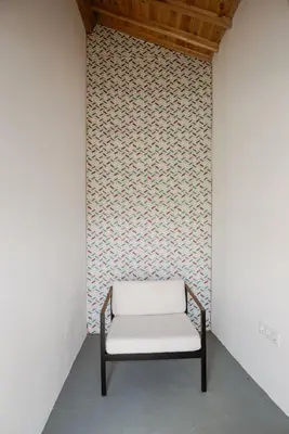 a white bench in a room with a wall at AZORINSITU - Casas da Ribeira in Vila do Porto