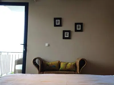 a bedroom with a bed and three pictures on the wall at Villa 17°West with Pool in Estreito da Calheta