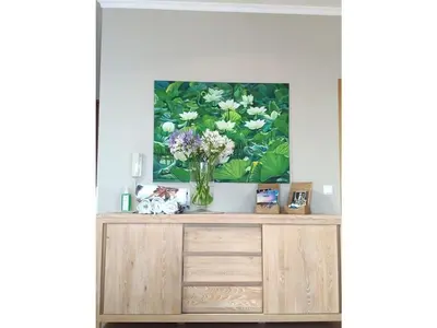 a vase of flowers on a cabinet in a room at Villa 17°West with Pool in Estreito da Calheta