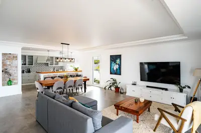a living room with a couch and a table at Quinta dos Louros in Estreito da Calheta