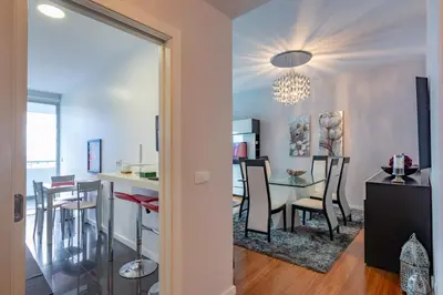 a dining room and living room with a table and chairs at Alameda in Funchal
