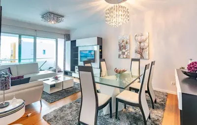 a dining room and living room with a glass table and chairs at Alameda in Funchal
