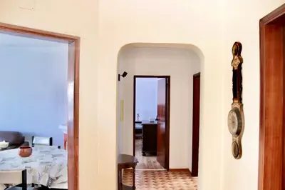 a hallway with a room with a table and a mirror at Casa do Afonso in Sagres