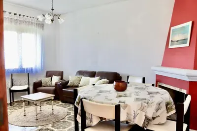 a living room with a table and a couch at Casa do Afonso in Sagres