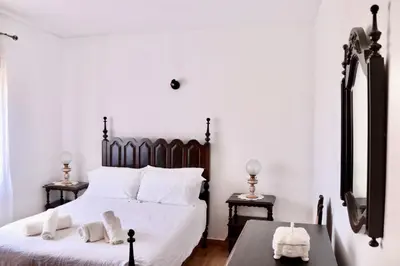 a bedroom with a large white bed with white pillows at Casa do Afonso in Sagres