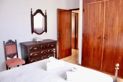 a bedroom with a bed and a dresser and a mirror at Casa do Afonso in Sagres