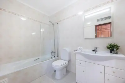 a bathroom with a toilet and a sink and a shower at Casa da Praia da Luz T2 plus 1 in Luz