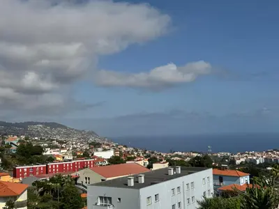 a view of a city with buildings and the ocean at Starry View in Funchal