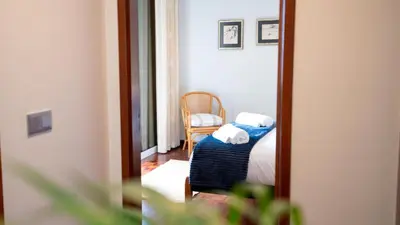a mirror in a room with a bed and a chair at Starry View in Funchal