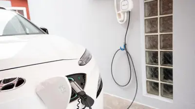 a white car is being hooked up to a hydrogen fueling nozzle at Starry View in Funchal