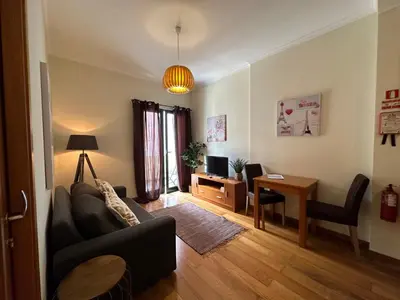a living room with a couch and a table at Apartamentos da Carreira in Funchal
