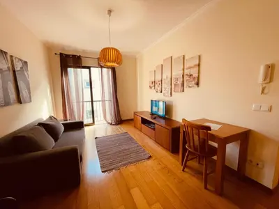 a living room with a table and a couch at Apartamentos da Carreira in Funchal