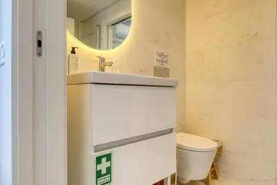 a bathroom with a sink and a toilet at Funchal Acqua Blue 5L, a Home in Madeira in Funchal