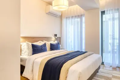 a bedroom with a large bed with blue pillows at Funchal Acqua Blue 5L, a Home in Madeira in Funchal