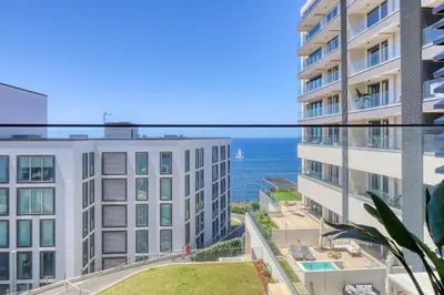 a view of the ocean from the balcony of a building at Funchal Acqua Blue 5L, a Home in Madeira in Funchal