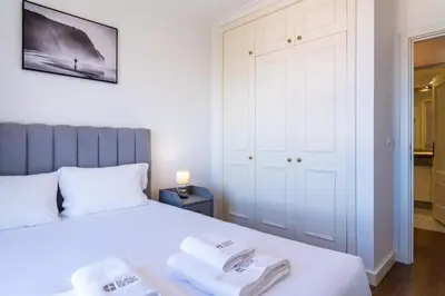 a bedroom with a bed with two towels on it at GuestReady - Caniço city view in Caniço