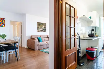 a living room and a dining room with a table at GuestReady - Caniço city view in Caniço