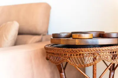 a rattan table with bowls on it next to a couch at GuestReady - Caniço city view in Caniço