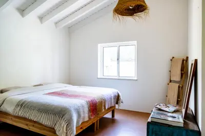 a bedroom with a bed and a window at Casa Pinho Vista in Aljezur
