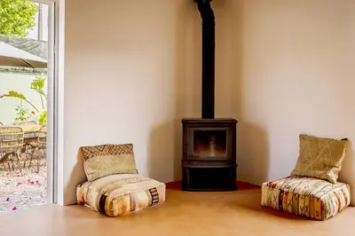 two chairs in front of a stove in a room at Casa Pinho Vista in Aljezur
