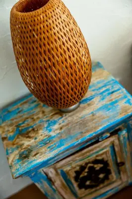 a wicker chair sitting on top of a table at Casa Pinho Vista in Aljezur