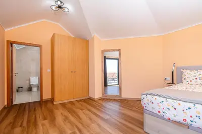 a bedroom with a bed and a bathroom at Casa Por Do Sol ll in Arco da Calheta