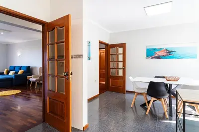 a living room with a table and a dining room at GuestReady – Stay Near Historic Reis Magos Fort in Caniço