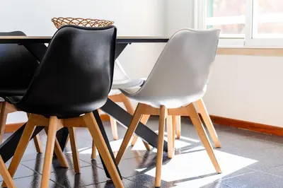 two black and white chairs sitting at a table at GuestReady – Stay Near Historic Reis Magos Fort in Caniço