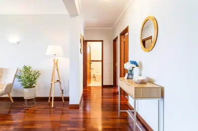 a living room with a table and a mirror at GuestReady – Stay Near Historic Reis Magos Fort in Caniço