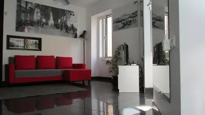 a living room with a red couch and a tv at João & Amália apartment by Rentallido in Funchal