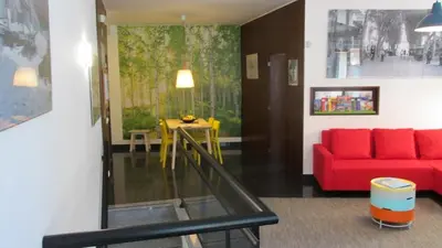 a living room with a red couch and a table at João & Amália apartment by Rentallido in Funchal