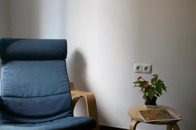 a blue chair in a room with a plant on a table at João & Amália apartment by Rentallido in Funchal