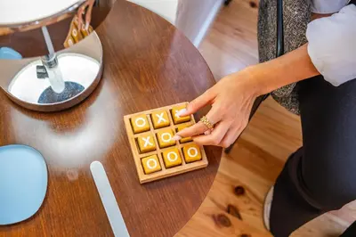 a woman playing a board game on a table at The Graceful Manor by Homie in Funchal