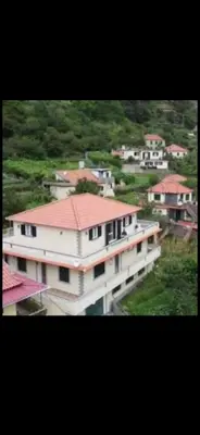 a large white building with a red roof at Danny's Rural Suite T1 in Curral das Freiras