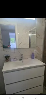 a bathroom with a white sink and a mirror at Danny's Rural Suite T1 in Curral das Freiras