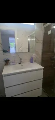 a bathroom with a white sink and a mirror at Danny's Rural Suite T1 in Curral das Freiras