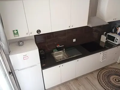 a kitchen with white cabinets and a sink at Danny's Rural Suite T1 in Curral das Freiras