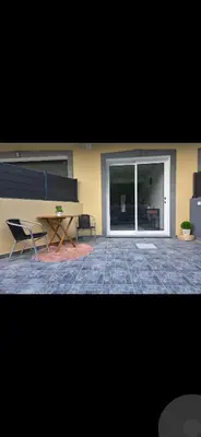 a building with two chairs and a bench in a courtyard at Danny's Rural Suite T1 in Curral das Freiras