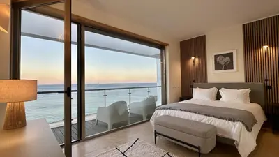 a bedroom with a bed and a view of the ocean at Luz by Check-in Portugal in Luz