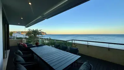 a balcony with a table and chairs and the ocean at Luz by Check-in Portugal in Luz