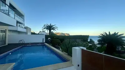 a swimming pool in front of a building with the ocean at Luz by Check-in Portugal in Luz