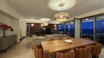 a dining room and living room with a table and chairs at Luz by Check-in Portugal in Luz