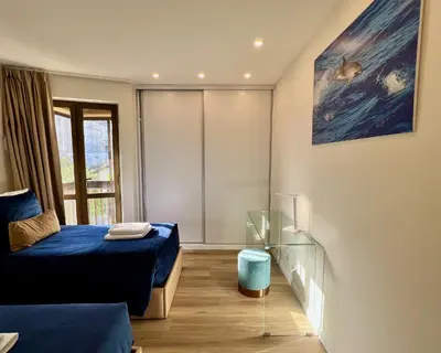 a bedroom with a bed and a glass table at Ocean Horizon in Funchal