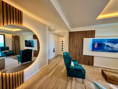 a waiting room with blue chairs and a mirror at Ocean Horizon in Funchal