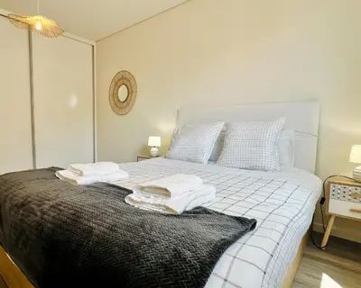 a bedroom with a bed with towels on it at Carmo Heritage Terrace in Funchal