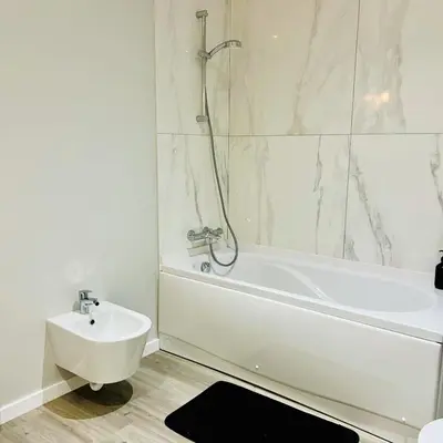 a white bathroom with a tub and a sink at Carmo Heritage Terrace in Funchal